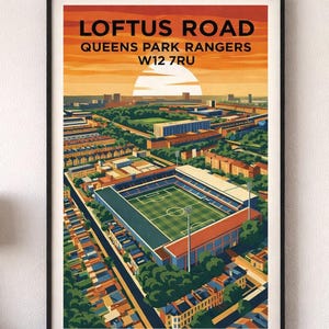 May include: A framed art print of Loftus Road stadium, home of Queens Park Rangers, with a sunset backdrop. The print features a detailed illustration of the stadium and surrounding neighborhood in shades of orange, green, and blue.