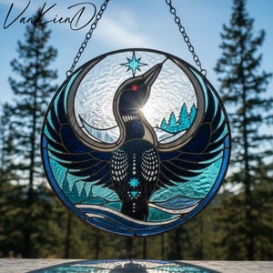 May include: Stained glass round panel featuring a loon with outstretched wings, in shades of blue, teal, and black. The design includes a star, trees, and a water scene. The panel is suspended by a chain, with the artist's signature in the upper left corner.