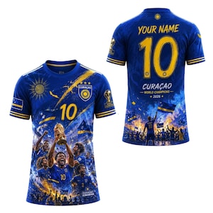 May include: Blue soccer jersey with gold accents, featuring the number 10 and the word "CURACAO". The front displays a team celebrating with a trophy. The back has "YOUR NAME" and "WORLD CHAMPIONS - 2026".