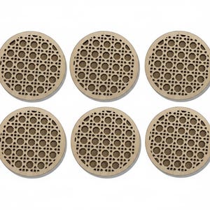 May include: Six round wooden coasters with a woven rattan design. The coasters are light brown with a darker brown woven pattern. They are arranged in two rows of three on a white background.