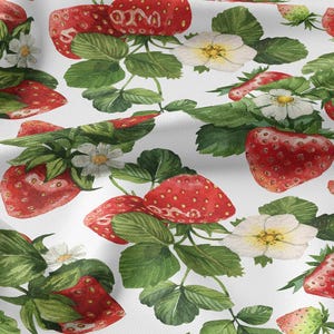 Pode incluir: Tecido branco com um padrão repetido de morangos vermelhos, folhas verdes e flores brancas. Os morangos variam em tamanho e criam um design fresco e de verão no tecido.