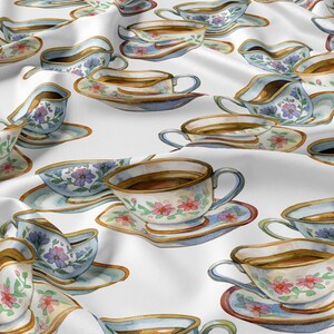 Pode incluir: Padrão aquarela de xícaras de chá, pires e cremeiras em um fundo branco. As xícaras e pires têm detalhes florais e acabamentos dourados. As cremeiras têm um design semelhante. O padrão é repetido no tecido.