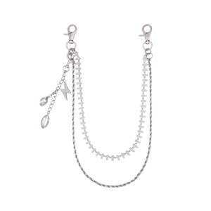 May include: Silver-toned chain accessory with two clasps. The chain features two layers, one with small, rectangular links and the other with a finer, textured design. Decorative charms include a lightning bolt and teardrop-shaped crystals.