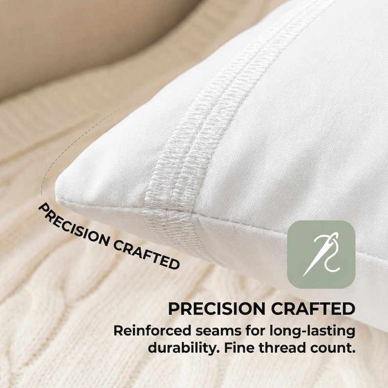 May include: Close-up of a white pillow with reinforced seams. The pillow has a stitched border and the words "PRECISION CRAFTED" are printed on the image. The image also includes a graphic of a needle and thread.
