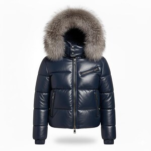 May include: A navy blue puffer jacket with a fur-trimmed hood. The jacket features a zip-up front, multiple pockets, and a high collar. The fur trim is a mix of gray and brown tones.