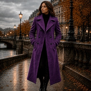 May include: A long, double-breasted purple wool coat featuring a wide notched collar, structured shoulders, and black buttons. The coat is worn over a black turtleneck sweater and black trousers, creating a layered look with a textured finish.