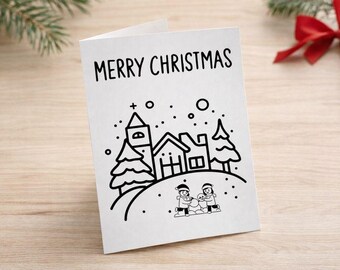 Puede incluir: Tarjeta de Navidad blanca plegada con las palabras "MERRY CHRISTMAS" en la parte superior. La tarjeta presenta una ilustración en blanco y negro de una escena de pueblo con casas, árboles y personas construyendo un muñeco de nieve. Caen copos de nieve.