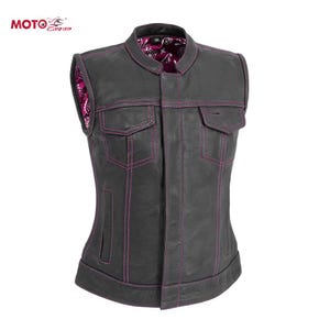 May include: A black leather vest with pink stitching and a paisley lining. The vest features two front pockets and a tailored fit. The Moto Grip logo is visible. A fashionable piece of outerwear, suitable for various occasions.