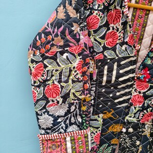 May include: A quilted jacket featuring a patchwork design with black, pink, and green floral and animal patterns. The garment has long sleeves with folded cuffs, a front opening, and a diamond-stitched texture throughout the fabric.