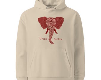 May include: A beige hoodie with a red elephant design. The elephant graphic features a detailed pattern and the text "Ursus Atelier" is printed below the elephant. The hoodie has a front pocket and a hood with drawstrings.