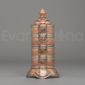 May include: A white ceramic mug with a black handle and the text "But First, Coffee" in a bold, black font. The mug is sitting on a wooden surface. The mug is approximately 4 inches tall.