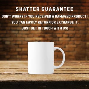 May include: A white ceramic mug with a curved handle, set against a wooden surface and a brick wall background. The text "SHATTER GUARANTEE" and a customer service message are displayed above the mug.
