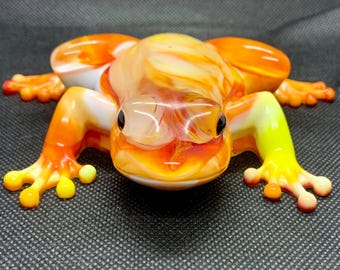 Orange, yellow, and white resin frog