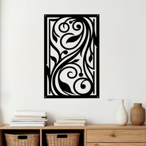 May include: Black metal wall art featuring a rectangular frame with an intricate floral design. The artwork showcases swirling vines, leaves, and circular elements, creating a decorative and elegant aesthetic. This piece is suitable for home decor.