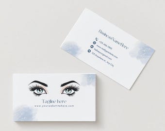 May include: Two business cards with a light background. One card features a stylized illustration of eyes with long eyelashes and the text "Tagline here" and "www.yourwebsitehere.com". The other card has contact information, including a phone number and email.