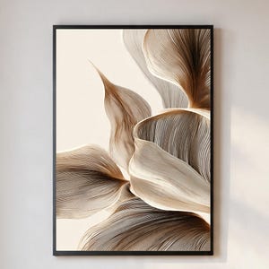 May include: Abstract floral art print in a black frame. The artwork features a detailed illustration of a flower with layered, textured petals in shades of brown and cream against a cream background. The lines create a sense of depth and movement.