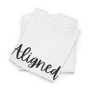 Puede incluir: Dos camisetas blancas dobladas y apiladas. La camiseta superior presenta la palabra "Aligned" en una fuente cursiva negra en la parte delantera. Las camisetas están hechas de un material suave, probablemente de algodón.