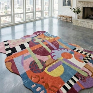 May include: A large, irregularly shaped rug with a vibrant abstract design. The rug features a mix of colors including red, orange, blue, purple, and green, with geometric shapes and patterns. The rug is placed on a concrete floor in a modern living space.