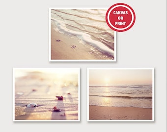 May include: Three framed beach prints. The top print shows waves washing onto a sandy shore with footprints. The bottom left print features a close-up of shells on the sand. The bottom right print shows the ocean at sunset. The text "CANVAS OR PRINT" is in a red circle.