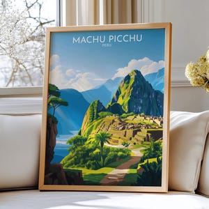 May include: A framed art print featuring Machu Picchu, Peru. The artwork depicts the ancient city with lush green mountains, a blue sky, and the text "Machu Picchu Peru". The print is in a light wooden frame.