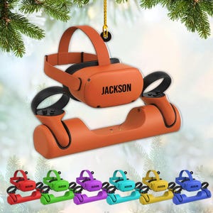 May include: Orange VR headset and controllers with the name "JACKSON" printed on the headset. A matching orange charging station is below. Additional VR headsets and charging stations in red, green, purple, teal, yellow, and blue are shown.