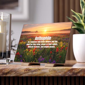 May include: A wooden block with the word "Anthophile" and its definition printed on it. The image on the block is a field of colorful wildflowers at sunset. The definition describes someone who loves flowers.