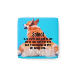 May include: Square magnet featuring a corgi dog in a "sploot" pose, with the dog's belly on the ground and legs stretched out. The text "Sploot" and its definition are displayed on a blue background.
