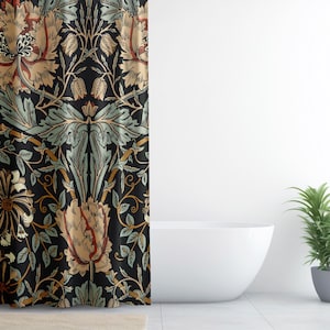 May include: A black shower curtain with a floral pattern in shades of brown, tan, and green. The design features stylized flowers and leaves. The curtain is hanging in a bathroom with a white tub and a potted plant.