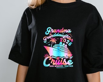 May include: Black t-shirt with a colorful graphic that reads "Grandma Granddaughter 2026 Cruise." The design includes a cruise ship, palm tree, and the words "2026 Memories Together."