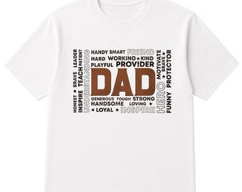 May include: White t-shirt with a brown "DAD" graphic. Surrounding the word are other words like "Honest", "Brave", "Leader", "Handy", "Smart", and "Friend". A perfect gift for Father's Day.