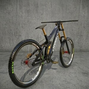 May include: A black and gold downhill mountain bike with "DOWN HILL" text on the frame. The bike has large tires with green lettering, a black seat, and gold suspension components. The bike is angled to the left.