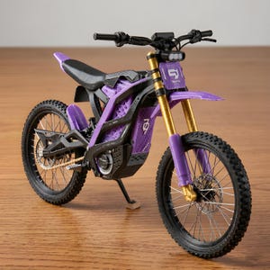 May include: A miniature electric dirt bike model in purple and black with gold-coloured front forks. The frame features a lattice design, a black seat, and a front number plate with the text 91. It includes black knobby tyres and a kickstand.