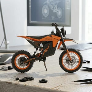May include: An orange and black toy electric motorcycle with the text "HILLIMIES" and "01" on the side. The motorcycle has a black seat, orange wheels, and a black frame. The motorcycle is on a wooden surface.
