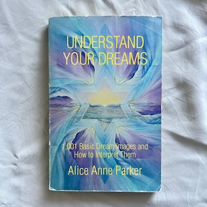 May include: A paperback book titled "UNDERSTAND YOUR DREAMS" with a blue and purple abstract cover design. The book includes the text "1,001 Basic Dream Images and How to Interpret Them" and the author's name, Alice Anne Parker.