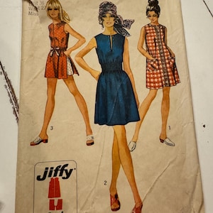 May include: Vintage Simplicity sewing pattern, size 14, featuring three dress designs. The pattern includes a Jiffy design with 2 or 4 main pattern pieces. The cover art shows illustrations of the dresses in various colors.