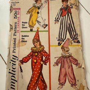 May include: Vintage Simplicity printed pattern for clown costumes. The pattern features four different clown outfits, including a yellow and white outfit, a black and white striped outfit, a red polka dot outfit, and a pink outfit. The pattern is for sizes 8-10.