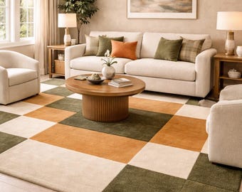May include: A large area rug featuring a repeating geometric checkerboard pattern in alternating squares of cream, olive green, and burnt orange. The rug has a textured, low-pile surface and covers a significant portion of the floor space.