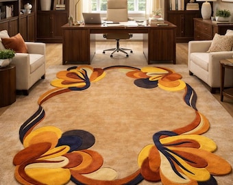 May include: A beige area rug with a floral design in shades of orange, yellow, and navy blue. The rug is in a home office setting with a large wooden desk, bookshelves, and two armchairs.