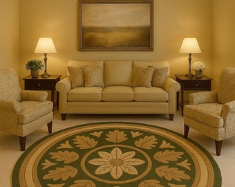 May include: A living room scene featuring a beige sofa, two armchairs, and a round rug with a floral and leaf design. The rug is primarily green with tan and beige accents. Two lamps sit on dark side tables.