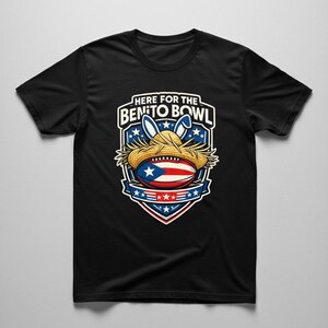 May include: Black t-shirt with a graphic of a football with the Puerto Rican flag, a straw hat, and bunny ears. The text "HERE FOR THE BENITO BOWL" is displayed above the graphic in a white font.