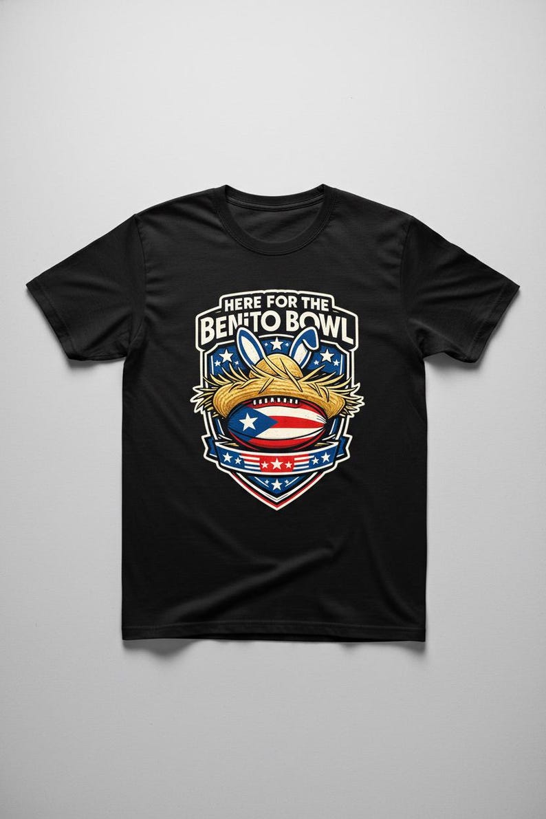 May include: Black t-shirt with a graphic of a football with the Puerto Rican flag, a straw hat, and bunny ears. The text "HERE FOR THE BENITO BOWL" is displayed above the graphic in a white font.