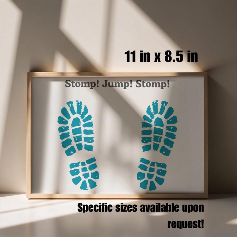 May include: Framed artwork with a white background featuring two turquoise footprints and the text "Stomp! Jump! Stomp!". The frame measures 11 inches by 8.5 inches. Additional sizes are available upon request.