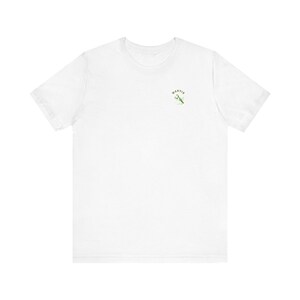 May include: White t-shirt featuring a small green and white mantis design with the word "MANTIS" in green above it. The shirt is made of a soft, lightweight fabric.