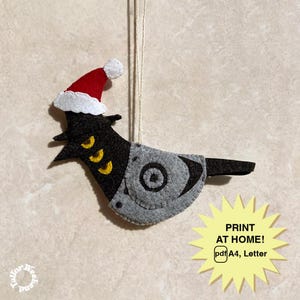 May include: A handmade felt Christmas ornament shaped like a bird, wearing a Santa hat. The bird is black and gray with yellow accents. The ornament hangs from a string. Text on the image says "PRINT AT HOME! pdf A4, Letter".