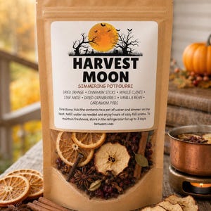 May include: A brown kraft paper pouch of Harvest Moon simmering potpourri. The label features a full moon, bats, and trees, listing ingredients like dried orange, cinnamon sticks, cloves, star anise, cranberries, and vanilla bean.
