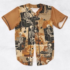 May include: Baseball jersey with a repeating pattern of skeletons enjoying coffee in a cafe setting. The jersey features brown sleeves and a black button-up front. The background has a collage of coffee beans and newspaper clippings.
