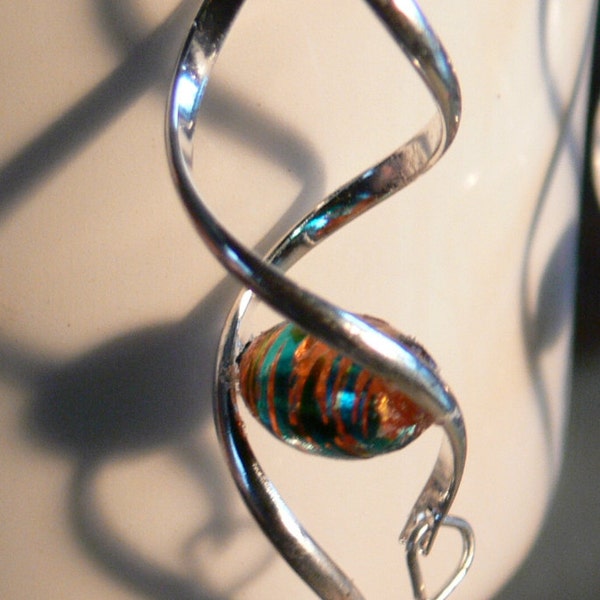Silver spiral earrings with orange and teal beads.