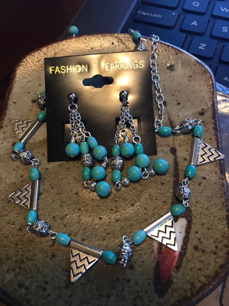 Silver and turquoise colored bead necklace and earrings