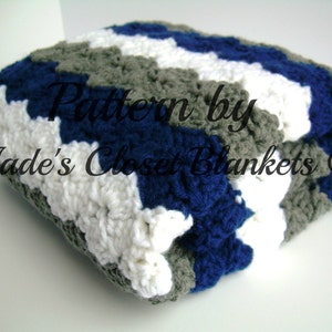 May include: A crocheted blanket with stripes of white, gray, and blue yarn. The blanket is folded in half and the text "Pattern by Jade's Closet Blankets ©" is visible.
