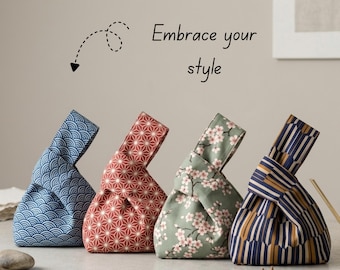 May include: Four fabric knot bags with wrist handles, featuring distinct patterns: blue wave, red geometric, green cherry blossom, and blue-gold vertical stripes. The text "Embrace your style" is printed above the bags with a dashed arrow.
